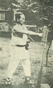 Gichin Funakoshi punching the makiwara